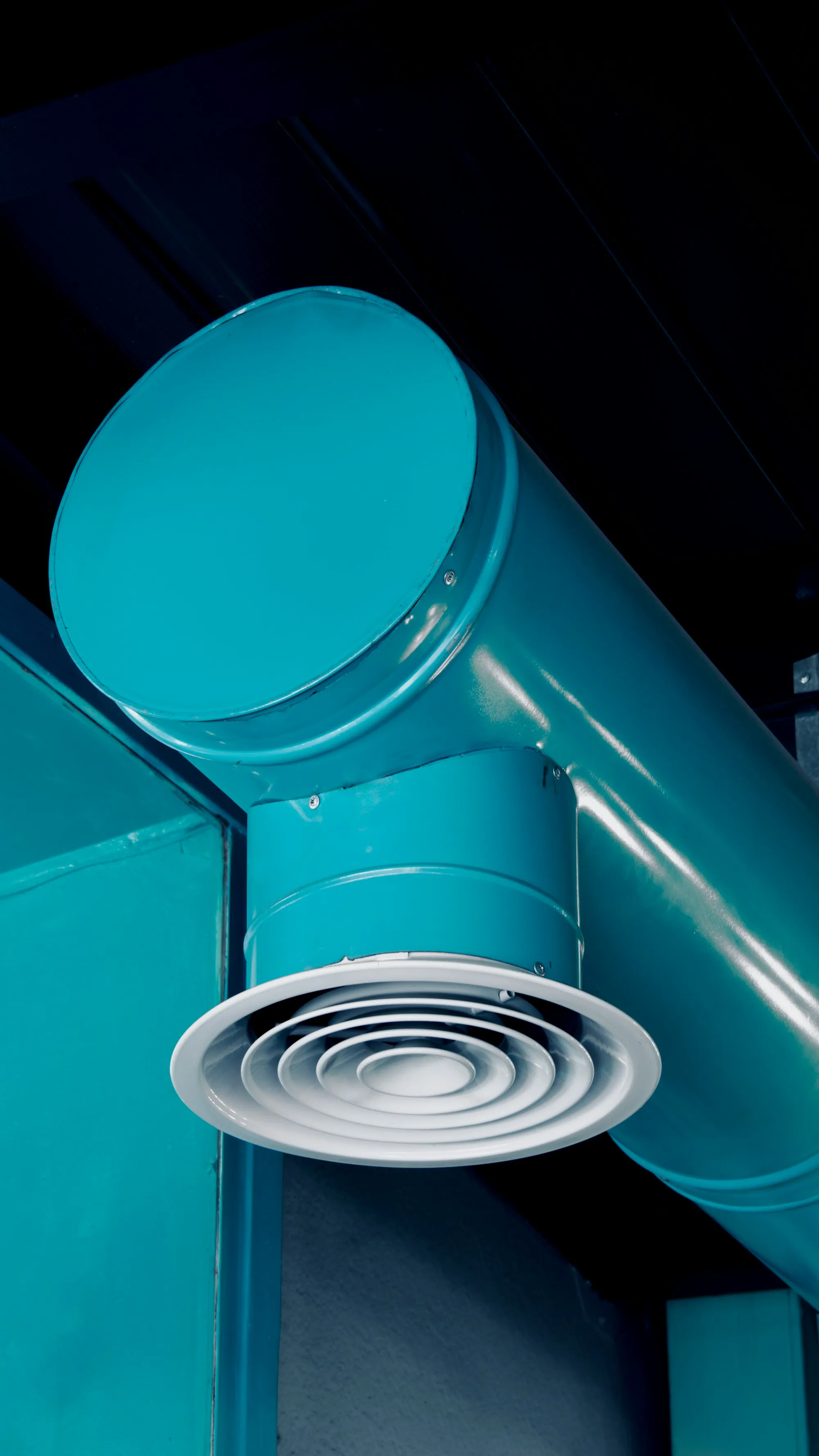 Teal painted round ductwork junction and elbow